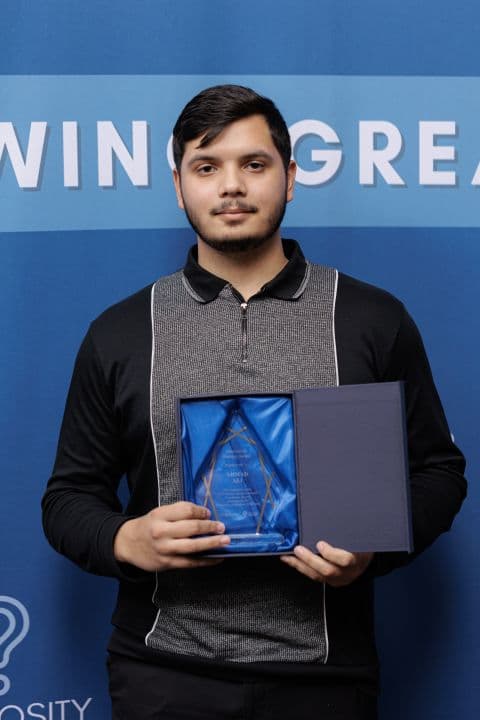 Ahmad Ali, founder of SaySpark, holding an engineering award
