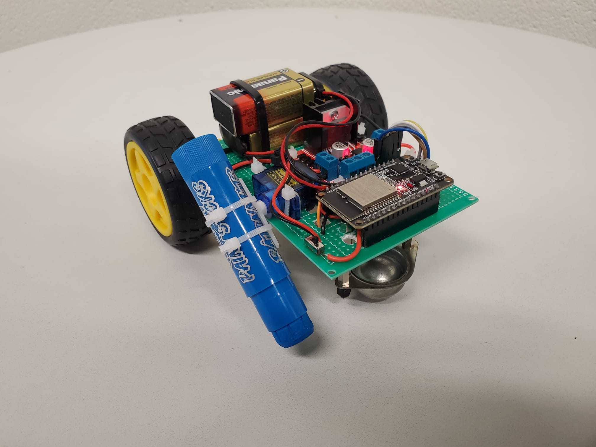 The first SaySpark prototype: perfboard, 9-volt battery, ESP32, and a blue marker zip-tied to a servo